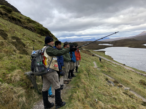 Dr. Stewart points out geologic features to students in Scotland